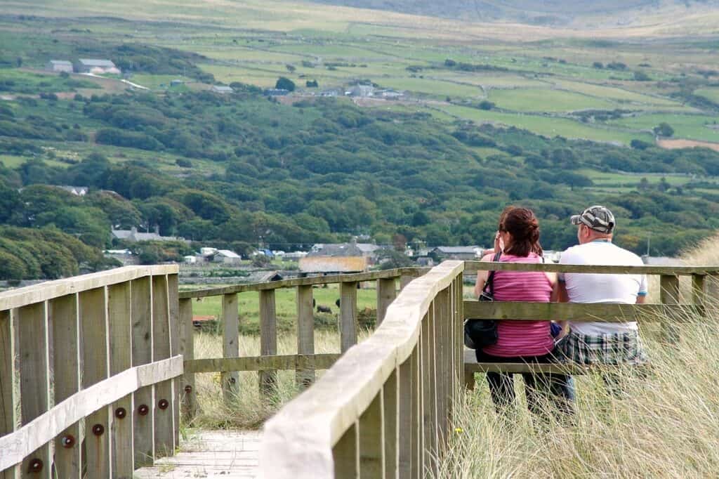 couple on bench looking at mountains