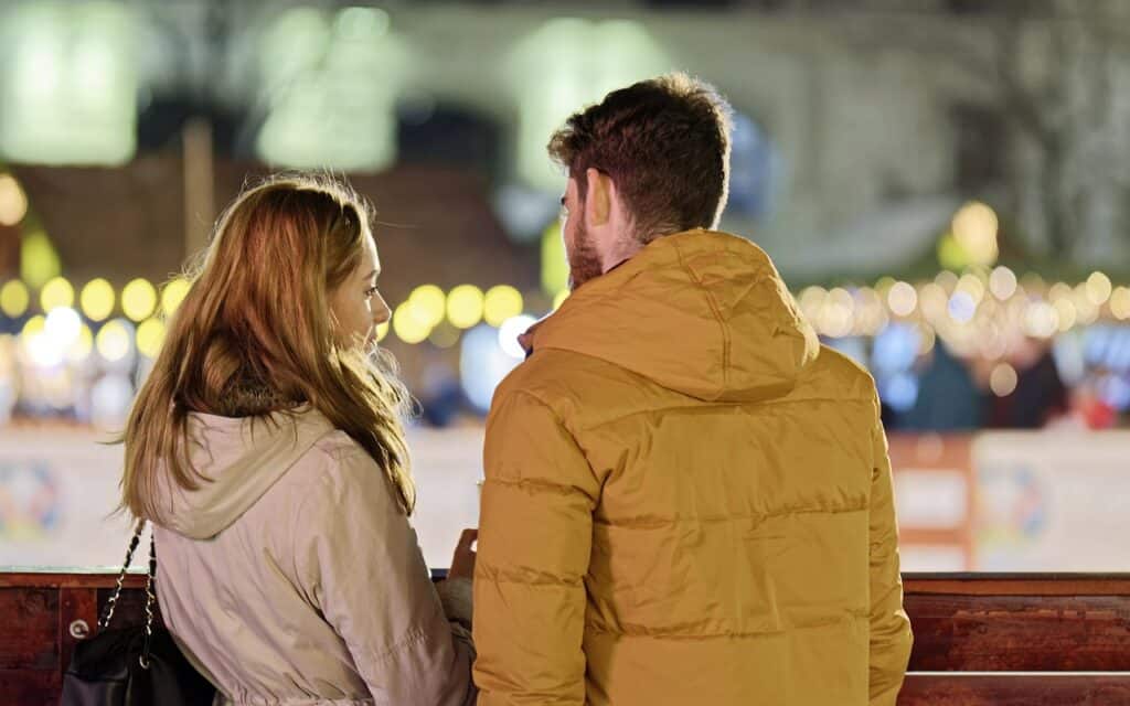 man and woman talking close together