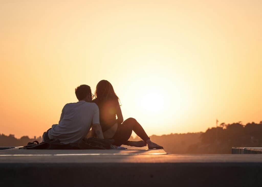 couple backs looking at sunrise