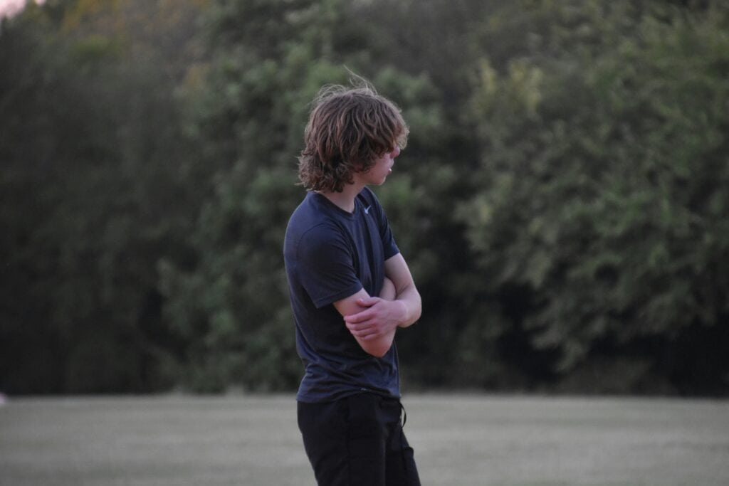 teen boy with arms crossed