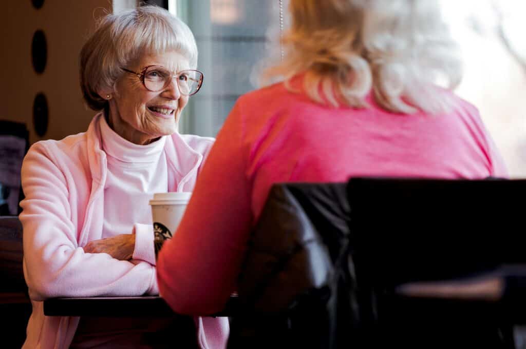 woman talking to daughter having coffee