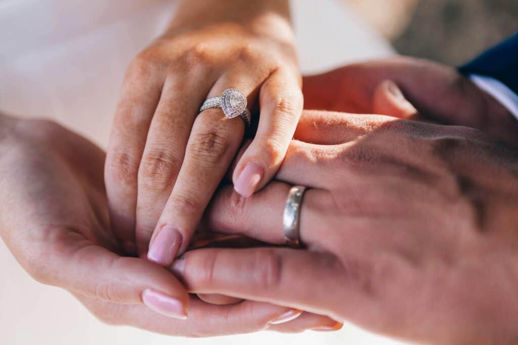 man and woman's hands with wedding rings