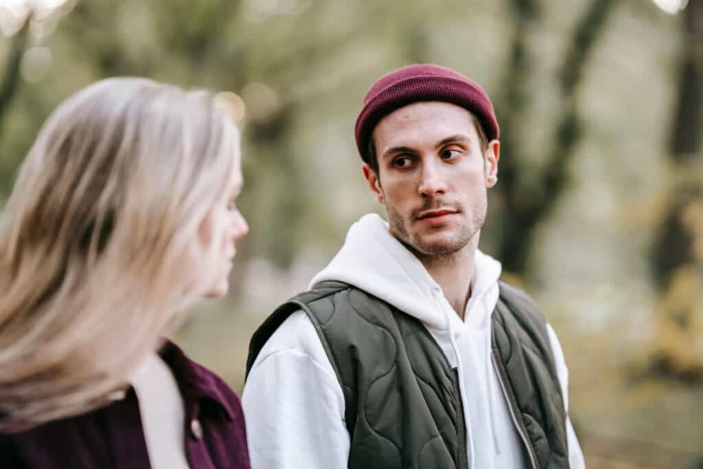 man and woman looking at each other unhappy