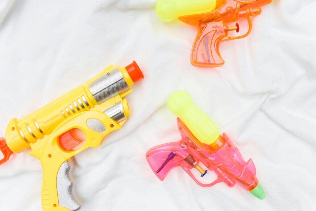 three colorful water pistol guns