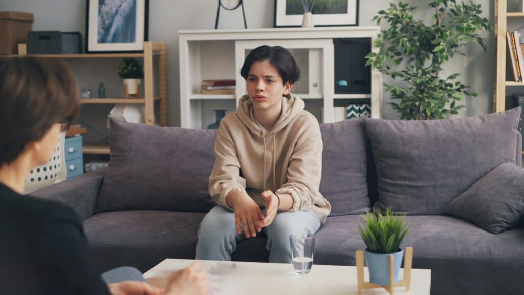 Woman mom talking to upset teen
