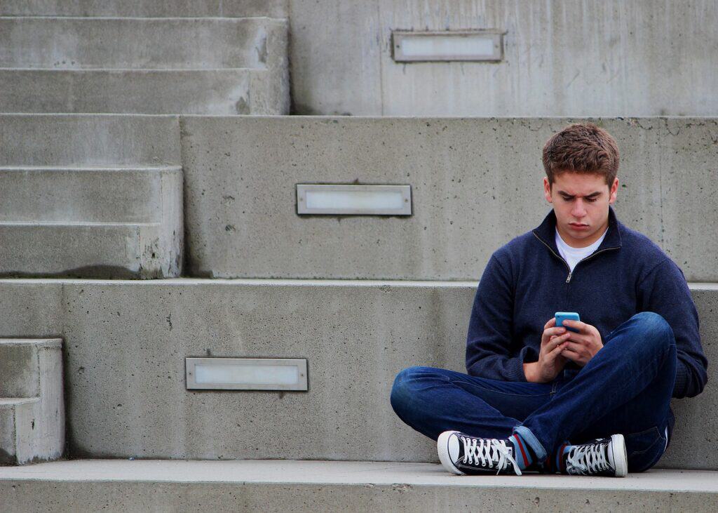 teen guy texting