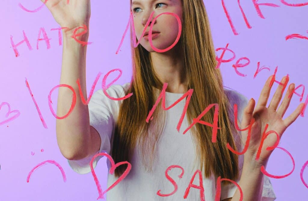 teen girl behind glass words love hate sad
